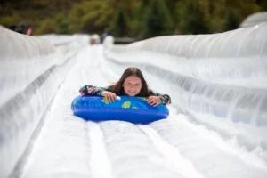 girl on water slide with blue tube
